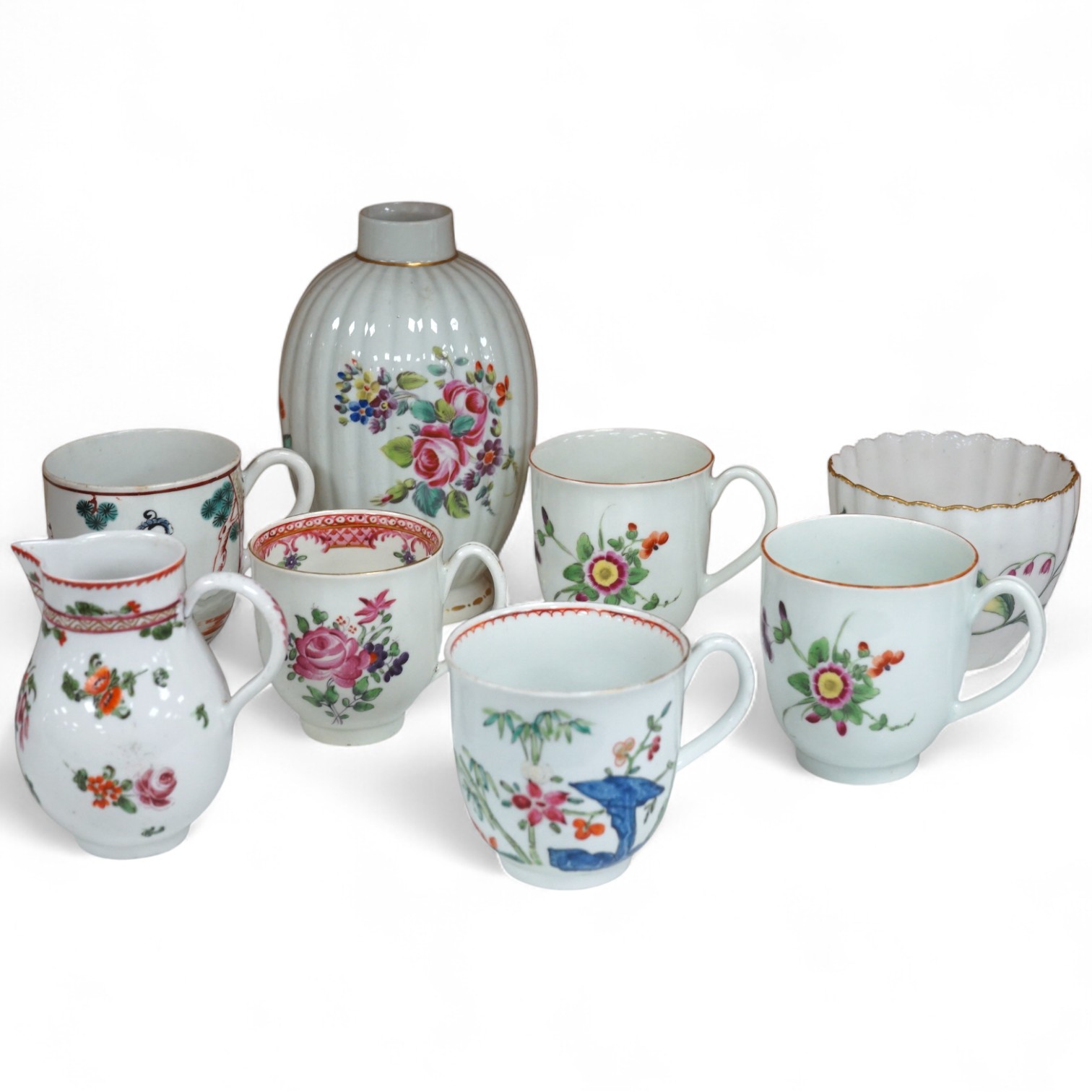 Worcester polychrome tea and coffee wares, c.1760-1780, comprising a tea caddy, a cream jug, five coffee cups and a fluted bowl, the latter with red anchor mark (8), largest tea caddy 14cm high.
